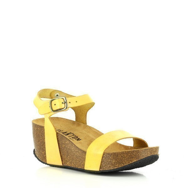 In this captivating photo, Plakton's 273023 Yellow Women's Wedge Sandals shine brightly, showcasing their vibrant hue and sleek design. The rich yellow leather straps elegantly wrap around the foot, leading to an adjustable ankle strap for a personalized fit. The cork sole adds a touch of natural charm while providing comfort and stability. Crafted with meticulous attention to detail and made in Spain, these sandals are the epitome of chic sophistication.