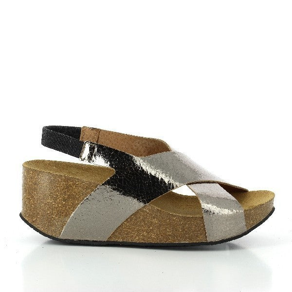In this captivating photo, Plakton's 275027 Silver Women's Wedge Sandals shine with elegance. The sleek silver leather, cross-strap design, and contoured cork sole exude sophistication. Crafted with care and featuring memory cushion technology, they're the epitome of style and comfort for the modern woman.