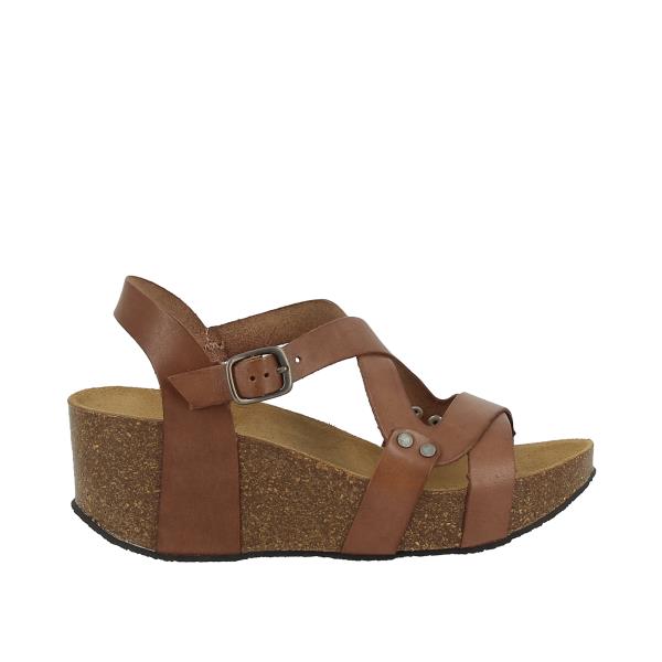 In this captivating image, Plakton's Brown Women's Wedge Sandals are showcased, emphasizing their chic design and earthy hue. The double cross-strapped front upper creates a diamond shape, while the adjustable ankle strap ensures a personalized fit. Crafted with premium leather and contoured cork footbed, these sandals offer both style and comfort. Perfect for adding a touch of sophistication to any smart-casual ensemble.