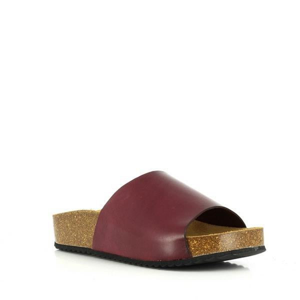 A captivating image showcasing Plakton's Plum Women's Slide. The soft upper and contrasting strap add a touch of elegance, while the contoured cork footbed promises unmatched comfort. Perfect for slipping on and going about your day with ease, these slides are a must-have addition to any wardrobe.