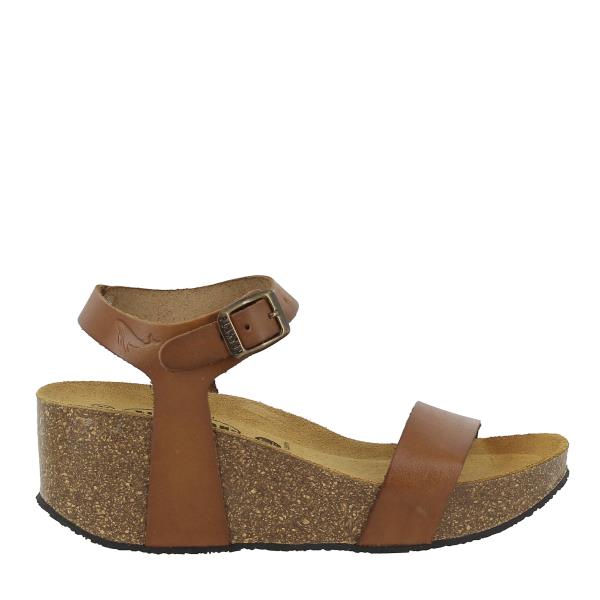 The photo showcases Plakton's 873023 Oak Women's Wedge Sandals, exuding elegance and sophistication. In the foreground, the sandals take center stage, with their sleek design and adjustable ankle straps catching the eye. The natural leather upper gleams softly in the light, while the rounded toe shape adds a touch of refinement.